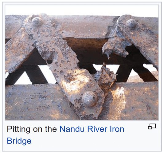 Corrosion and pitting on a metal bridge 