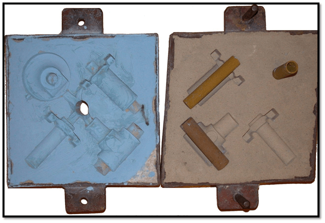 Cope & drag (top and bottom halves of a sand mold), with cores in place on the drag